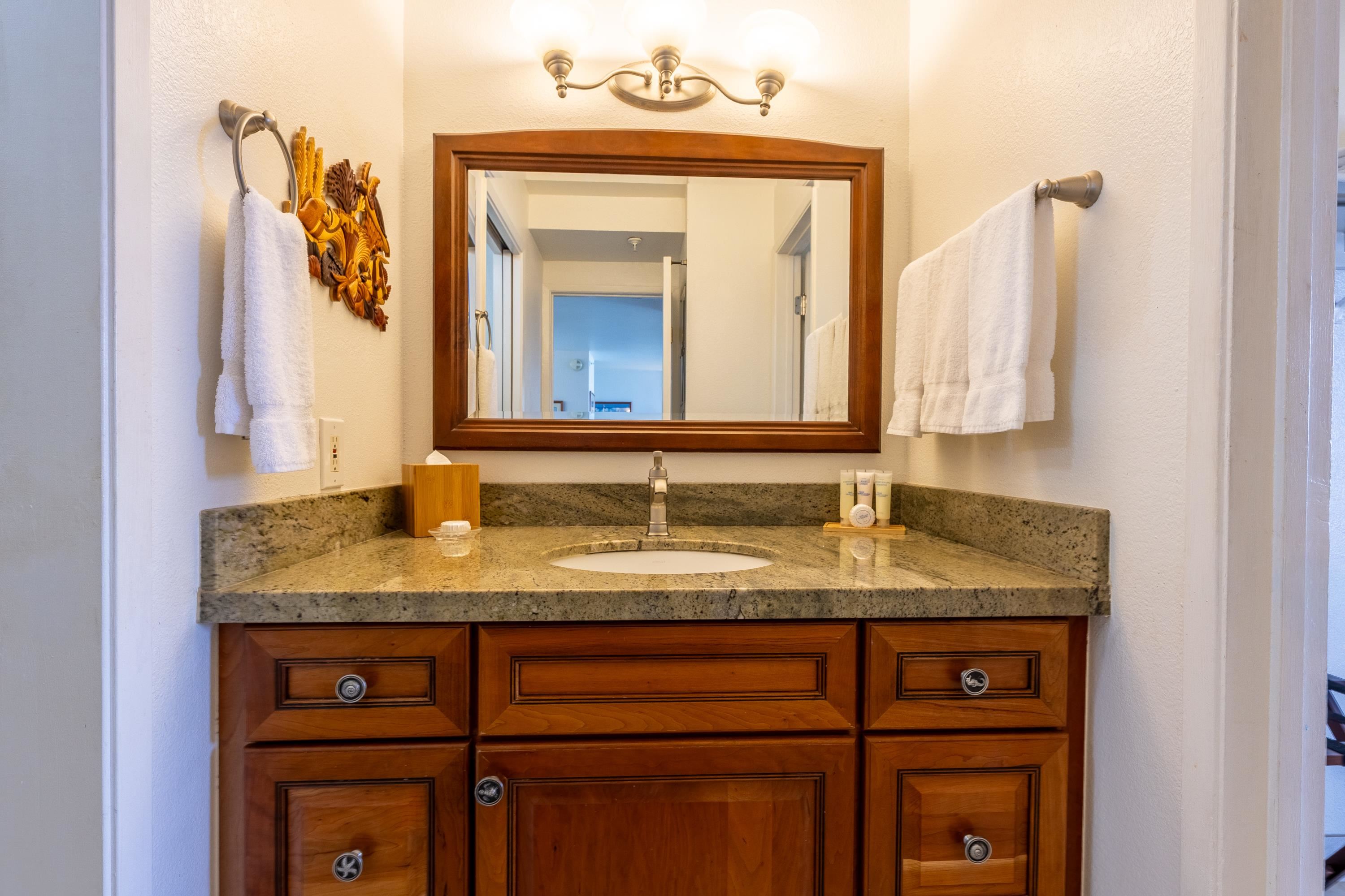 4365 Lower Honoapiilani Road, Unit 1008 Lahaina, HI 96761 - Photo 9 of 31 a bathroom with a granite countertop sink and a mirror