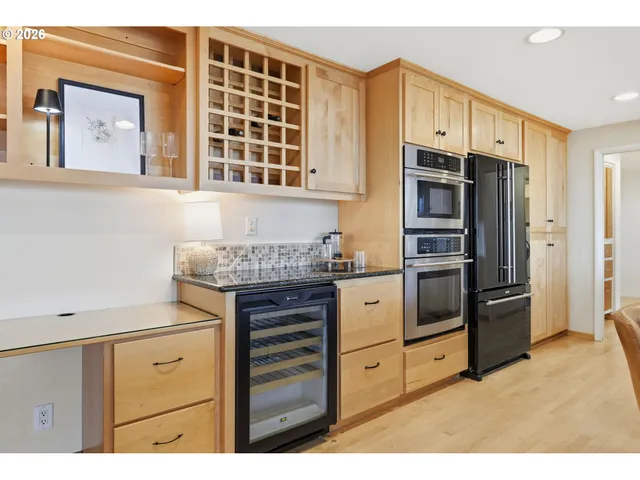 a kitchen with stainless steel appliances a refrigerator and cabinets