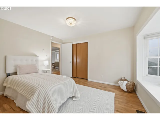 a spacious bedroom with a bed and a window