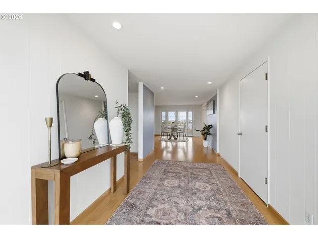 a view of a livingroom with furniture a ceiling fan and wooden floor