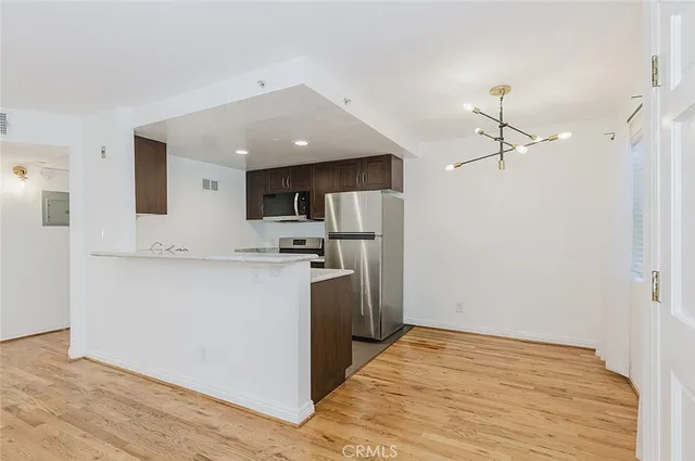 a view of a kitchen with a sink and a refrigerator