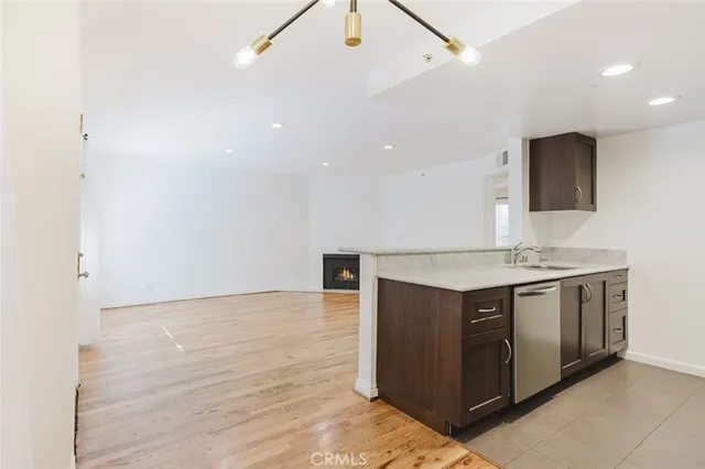 a view of kitchen with stainless steel appliances granite countertop a sink and a stove