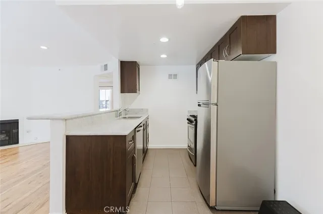 a kitchen with a refrigerator and a sink
