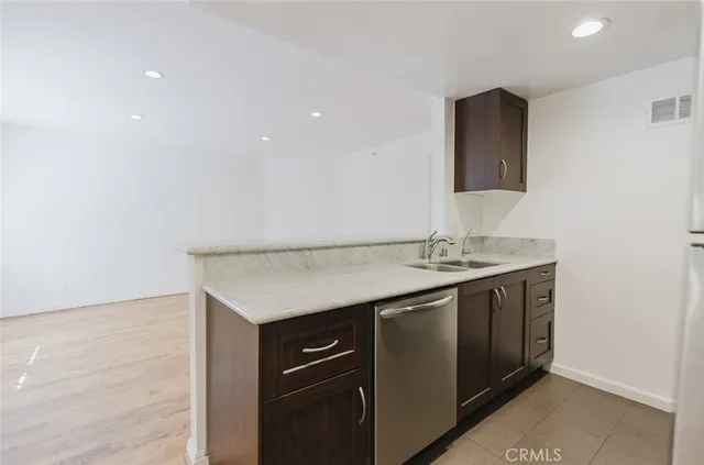 a kitchen with a sink and a refrigerator
