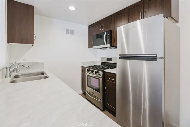 a white refrigerator freezer sitting in a kitchen