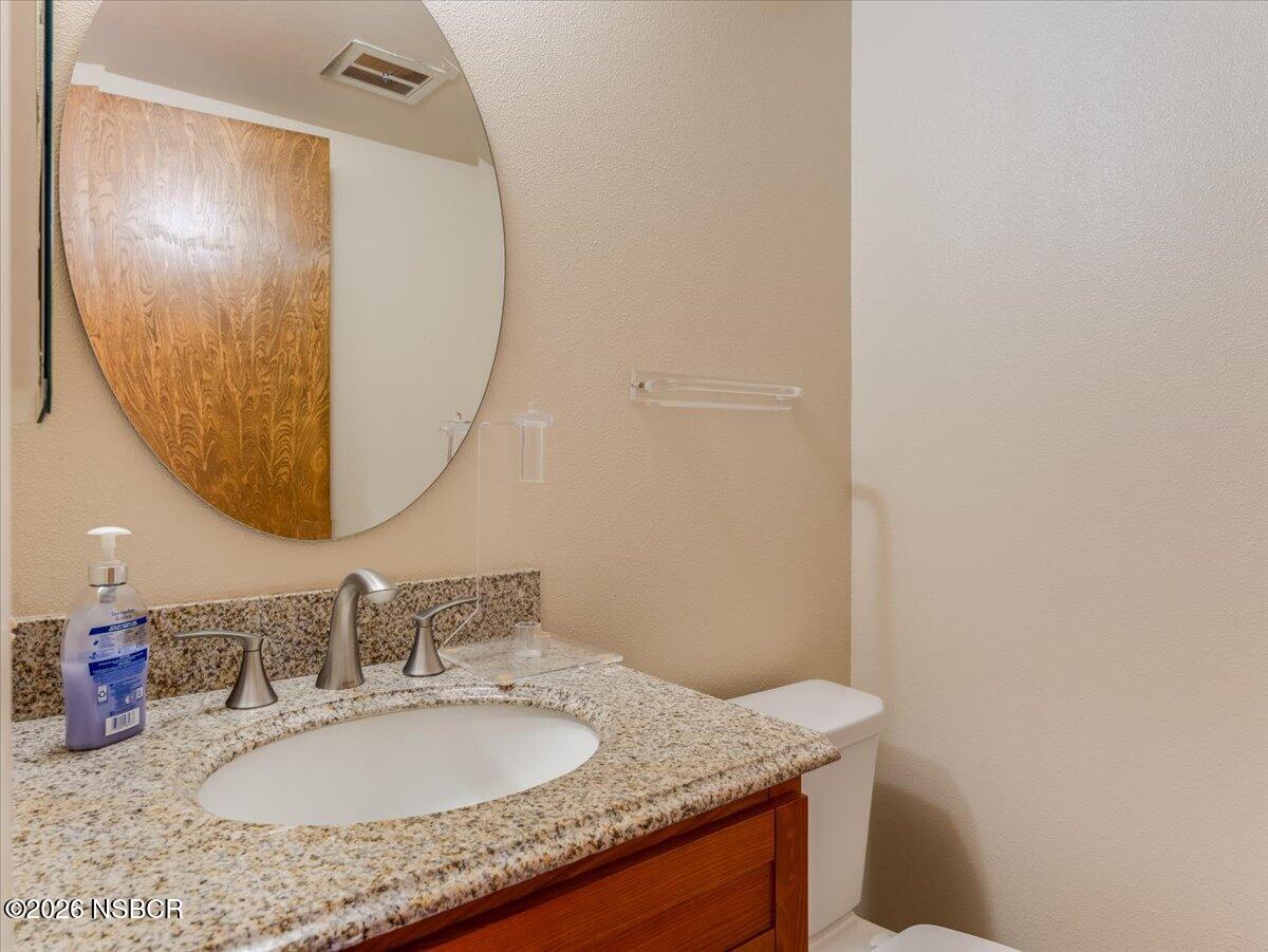 360 Tallyho Road Santa Maria, CA 93455 - Photo 32 of 72 a bathroom with a granite countertop sink and a mirror