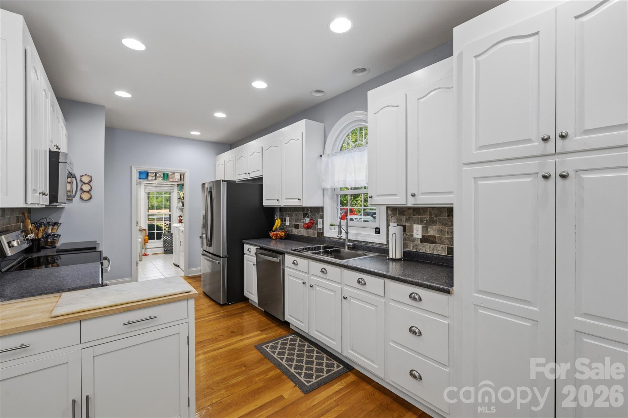 710 Sleepy Hollow Road Midland, NC 28107 - Photo 9 of 29 a kitchen with stainless steel appliances granite countertop a refrigerator sink and cabinets