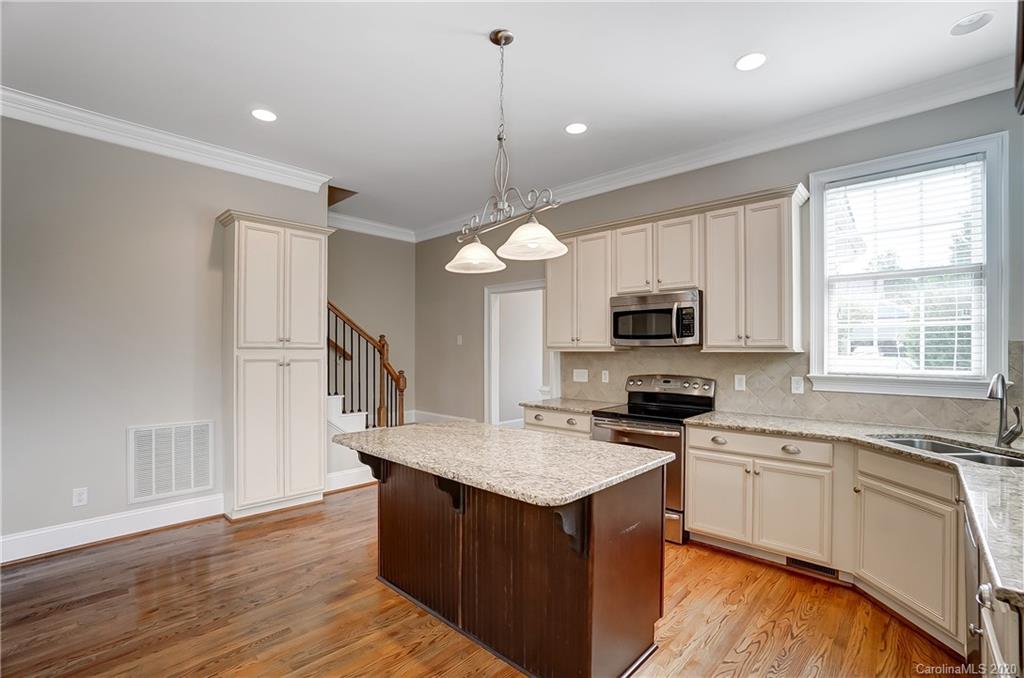 718 Revival Row Fort Mill, SC 29708 - Photo 14 of 47 a kitchen with granite countertop a sink cabinets and window
