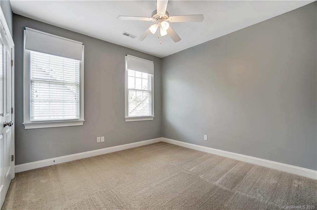 718 Revival Row Fort Mill, SC 29708 - Photo 33 of 47 an empty room with a window and ceiling fan