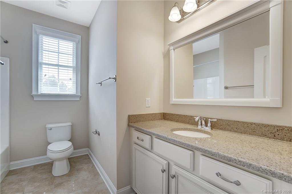 718 Revival Row Fort Mill, SC 29708 - Photo 36 of 47 a bathroom with a granite countertop sink a toilet and a mirror