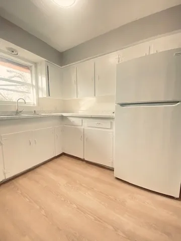 a view of an empty room with a kitchen