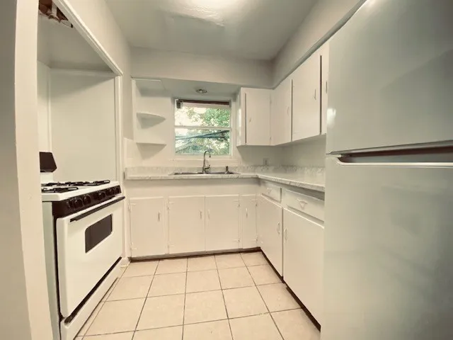 a kitchen with a stove a sink and a refrigerator