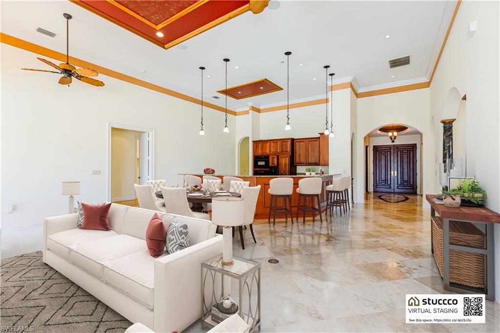 19930 Markward Crossing Estero, FL 33928 - Photo 11 of 40 Living room with a high ceiling, crown molding, ceiling fan, and light tile floors