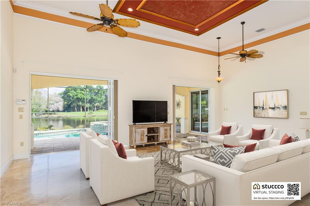 19930 Markward Crossing Estero, FL 33928 - Photo 9 of 40 Living room with tile flooring, a high ceiling, ceiling fan, and a water view