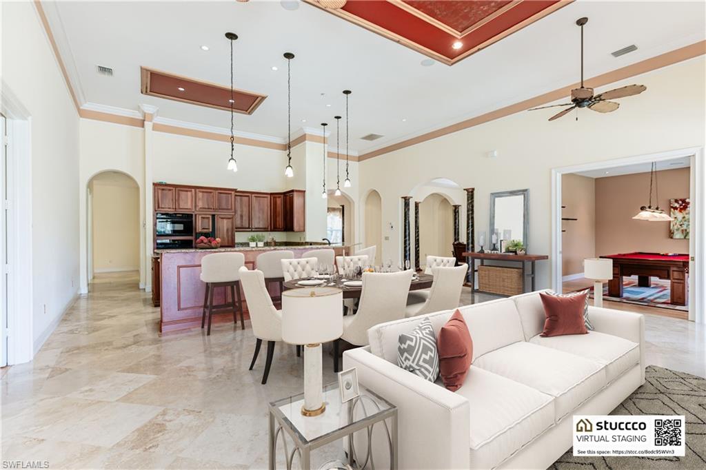 19930 Markward Crossing Estero, FL 33928 - Photo 10 of 40 Living room featuring a high ceiling, ceiling fan, ornamental molding, and light tile floors