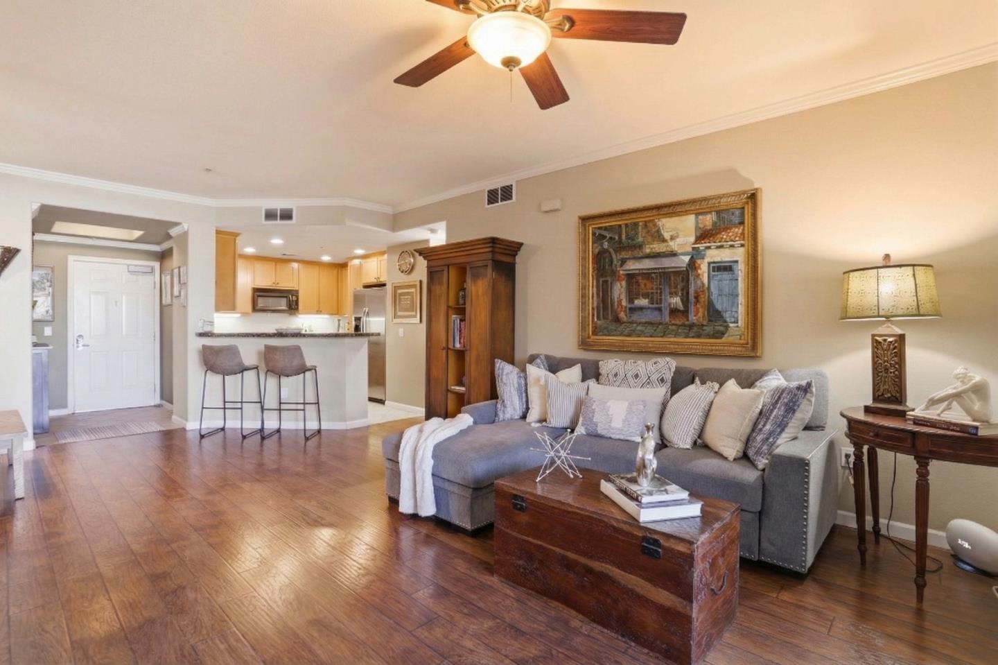 a living room with furniture and wooden floor