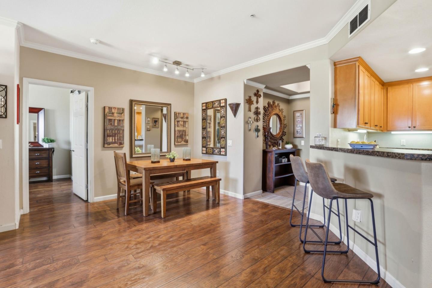 1310 Saddle Rack Street, Unit 314 San Jose, CA 95126 - Photo 11 of 43 a view of a dining room with furniture and wooden floor