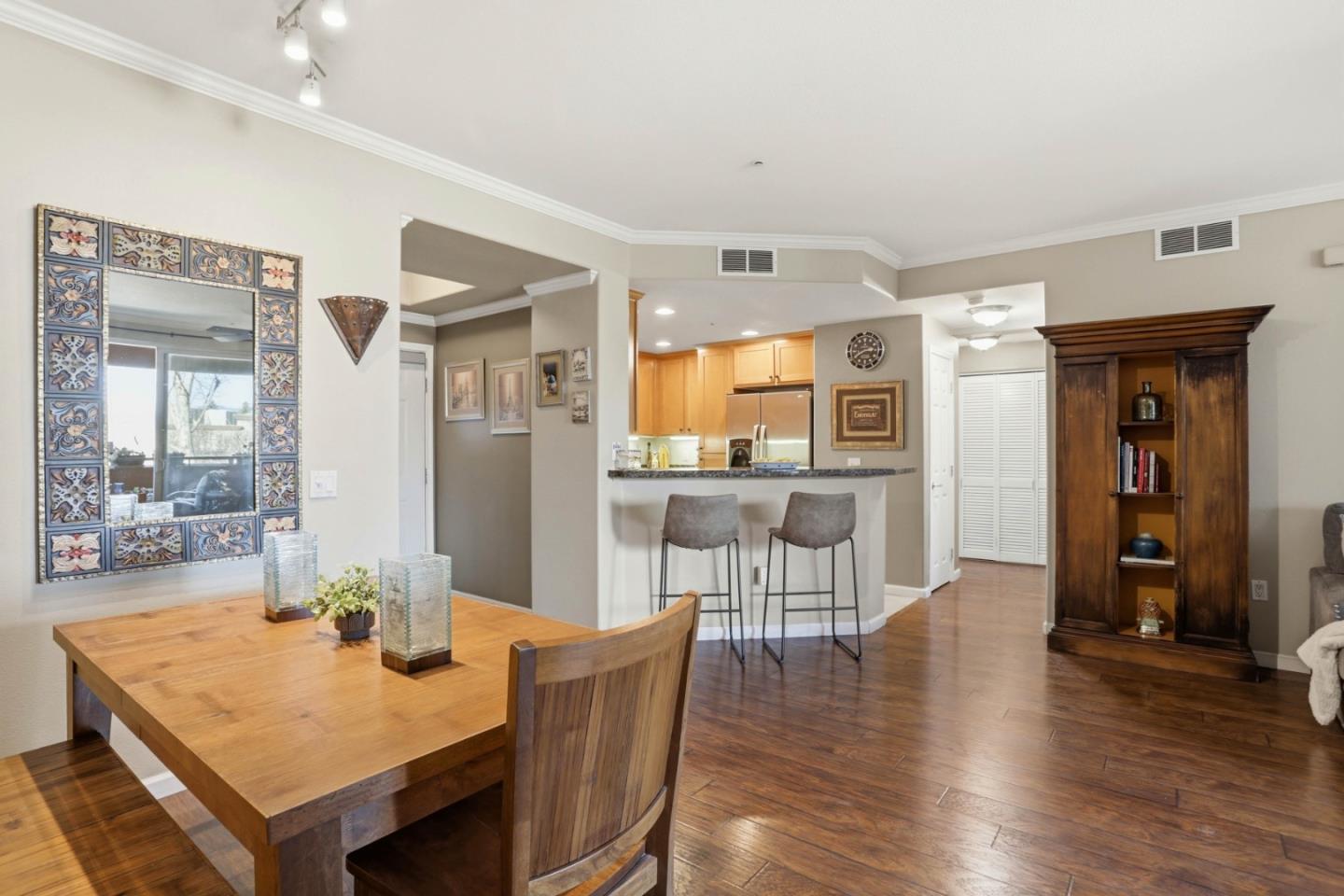 1310 Saddle Rack Street, Unit 314 San Jose, CA 95126 - Photo 14 of 43 a view of a dining room with furniture and wooden floor