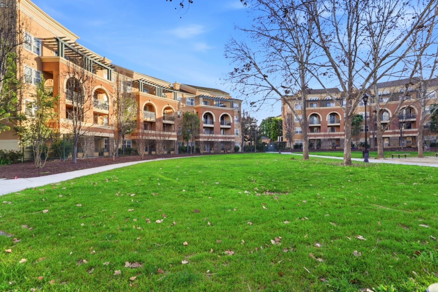 1310 Saddle Rack Street, Unit 314 San Jose, CA 95126 - Photo 32 of 43 a large brick building with a big yard and large trees