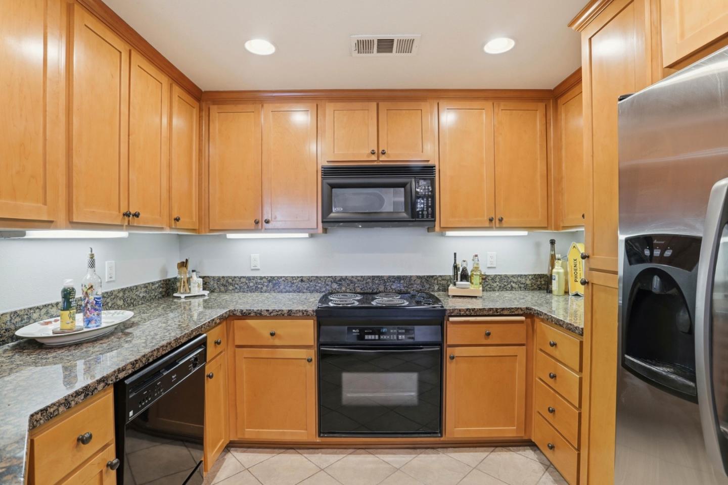 1310 Saddle Rack Street, Unit 314 San Jose, CA 95126 - Photo 10 of 43 a kitchen with stainless steel appliances granite countertop a stove a sink and a refrigerator