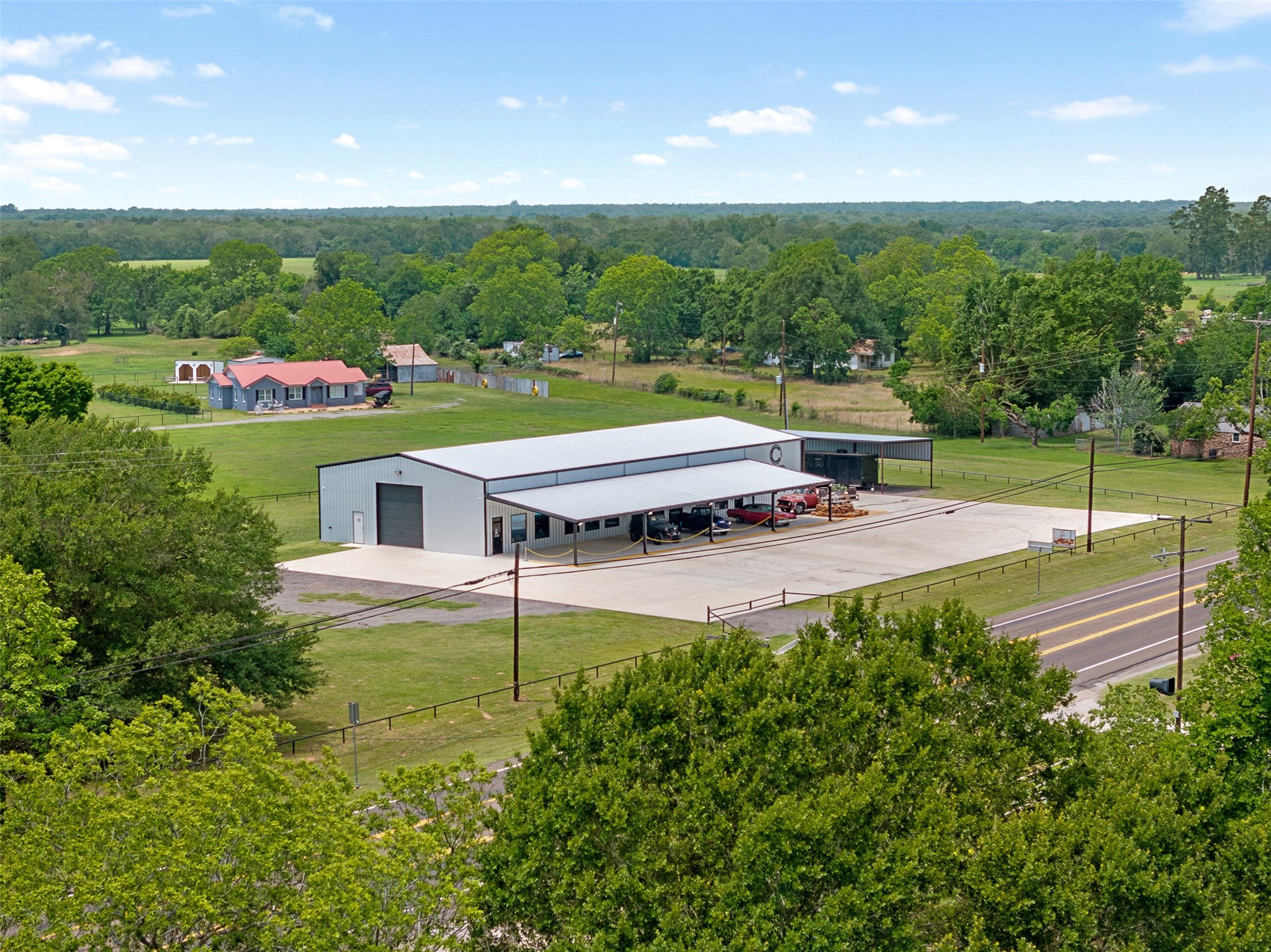 1229 Highway 36 Caldwell, TX 77836 - Photo 19 of 31 a view of a swimming pool with lawn chairs plants and large trees