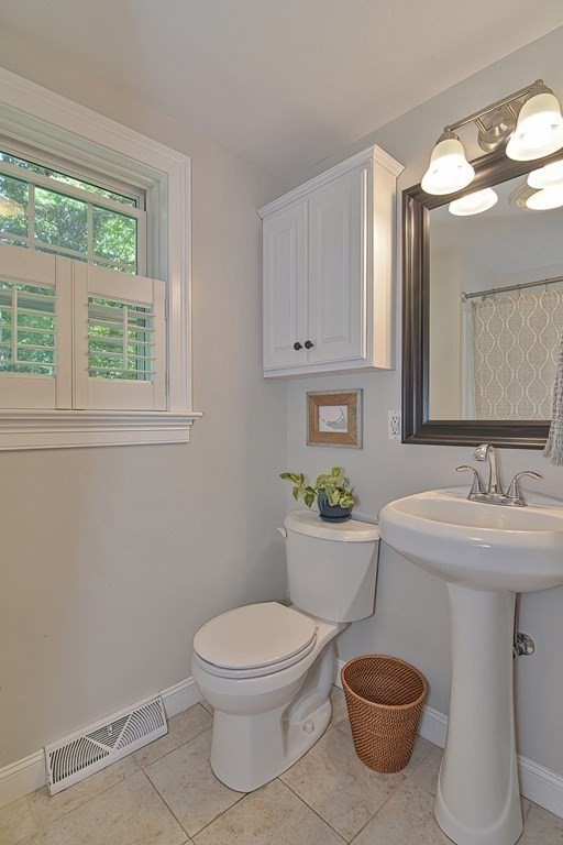 53 Warren Street Upton, MA 01568 - Photo 15 of 41 a bathroom with a toilet a sink and a window