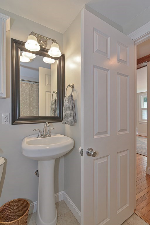 53 Warren Street Upton, MA 01568 - Photo 16 of 41 a bathroom with a toilet sink and mirror
