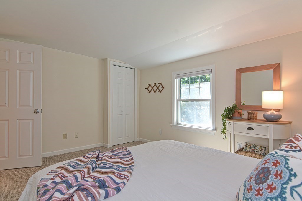 53 Warren Street Upton, MA 01568 - Photo 26 of 41 a bedroom with a bed and a window in it