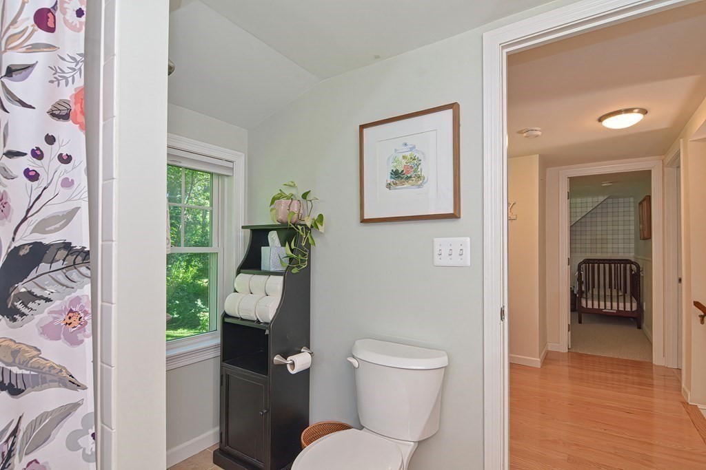 53 Warren Street Upton, MA 01568 - Photo 28 of 41 a white toilet sitting next to a bathroom sink