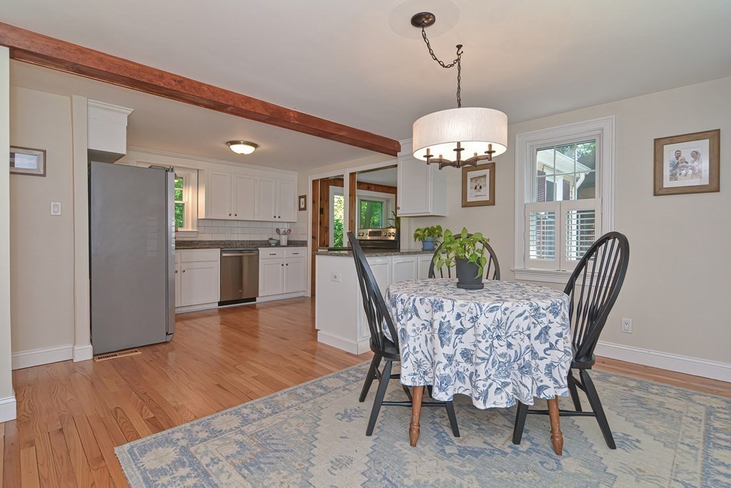 53 Warren Street Upton, MA 01568 - Photo 6 of 41 a dining room with furniture a chandelier and wooden floor