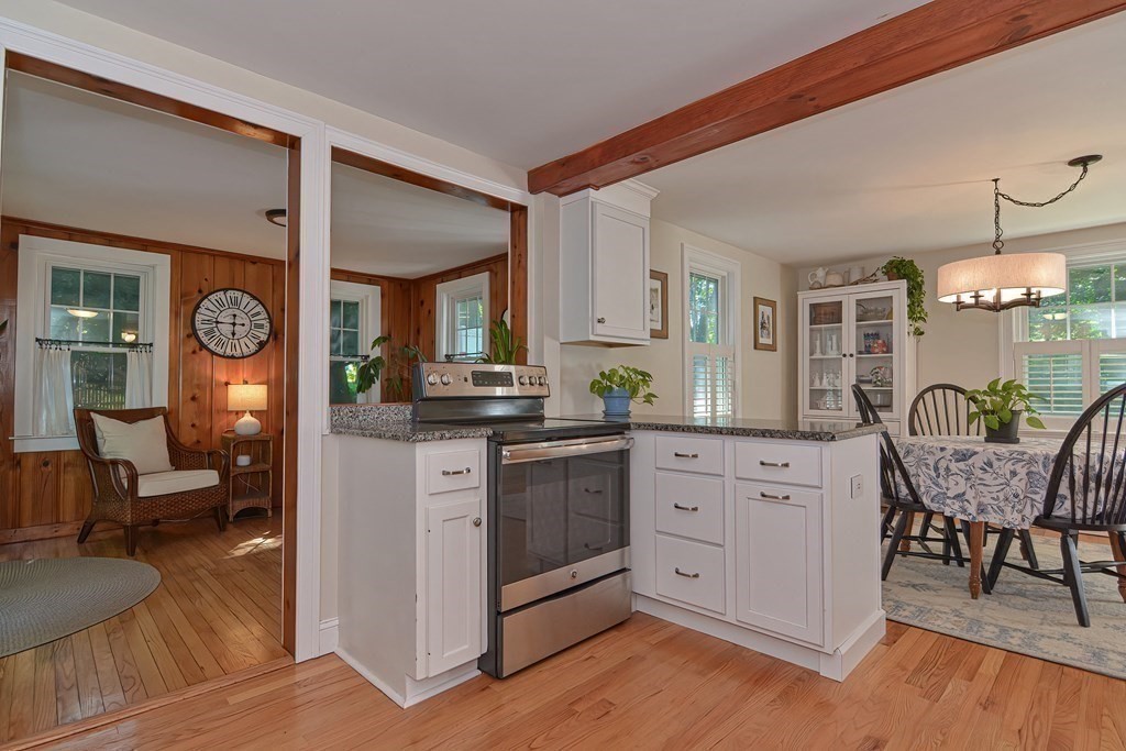 53 Warren Street Upton, MA 01568 - Photo 8 of 41 a kitchen with white cabinets and wooden floor
