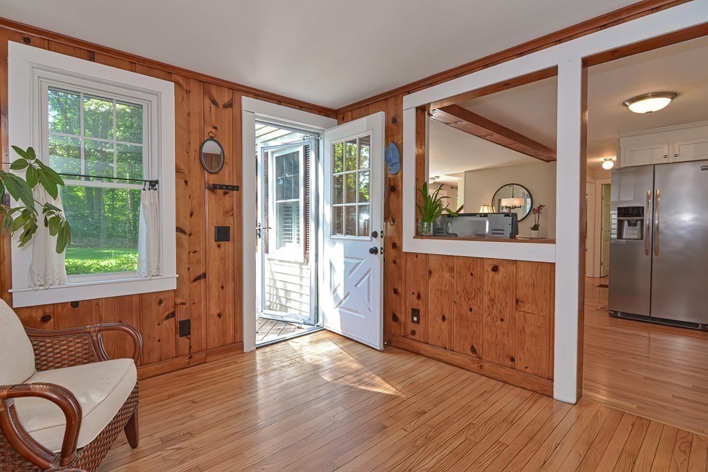 53 Warren Street Upton, MA 01568 - Photo 9 of 41 a view of a hallway with wooden floor windows and a living room
