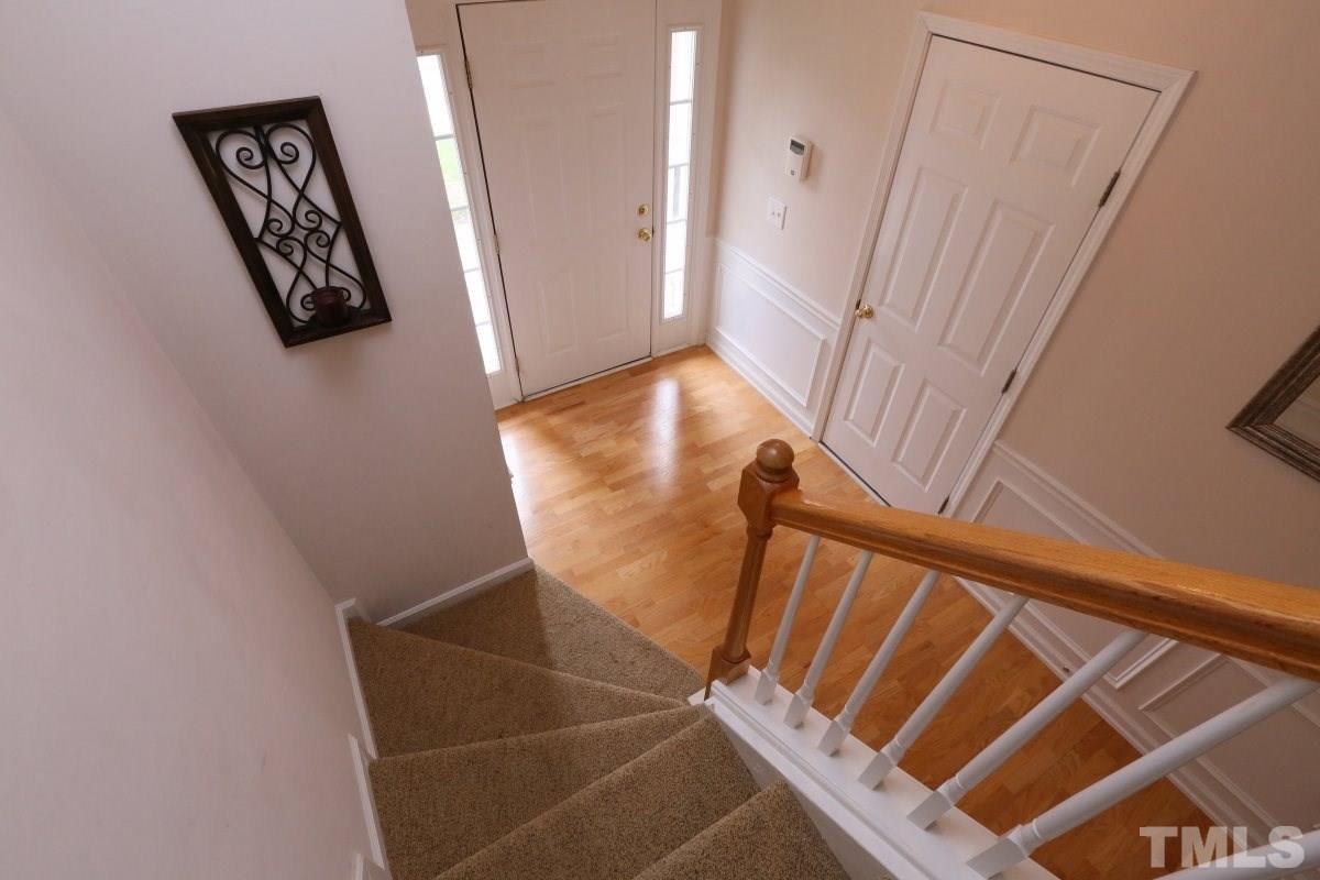 7113 Lovko Lane Raleigh, NC 27613 - Photo 12 of 25 a view of an entryway with wooden floor and door