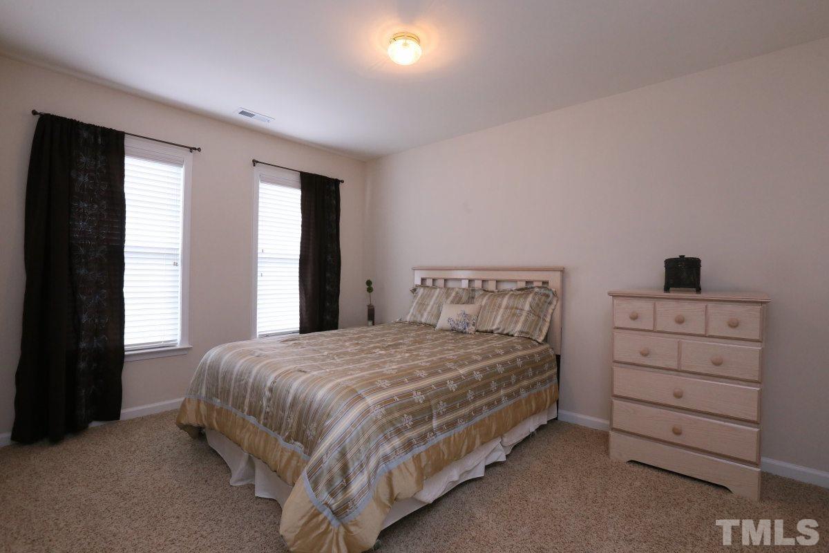 7113 Lovko Lane Raleigh, NC 27613 - Photo 17 of 25 a bedroom with a bed and a window