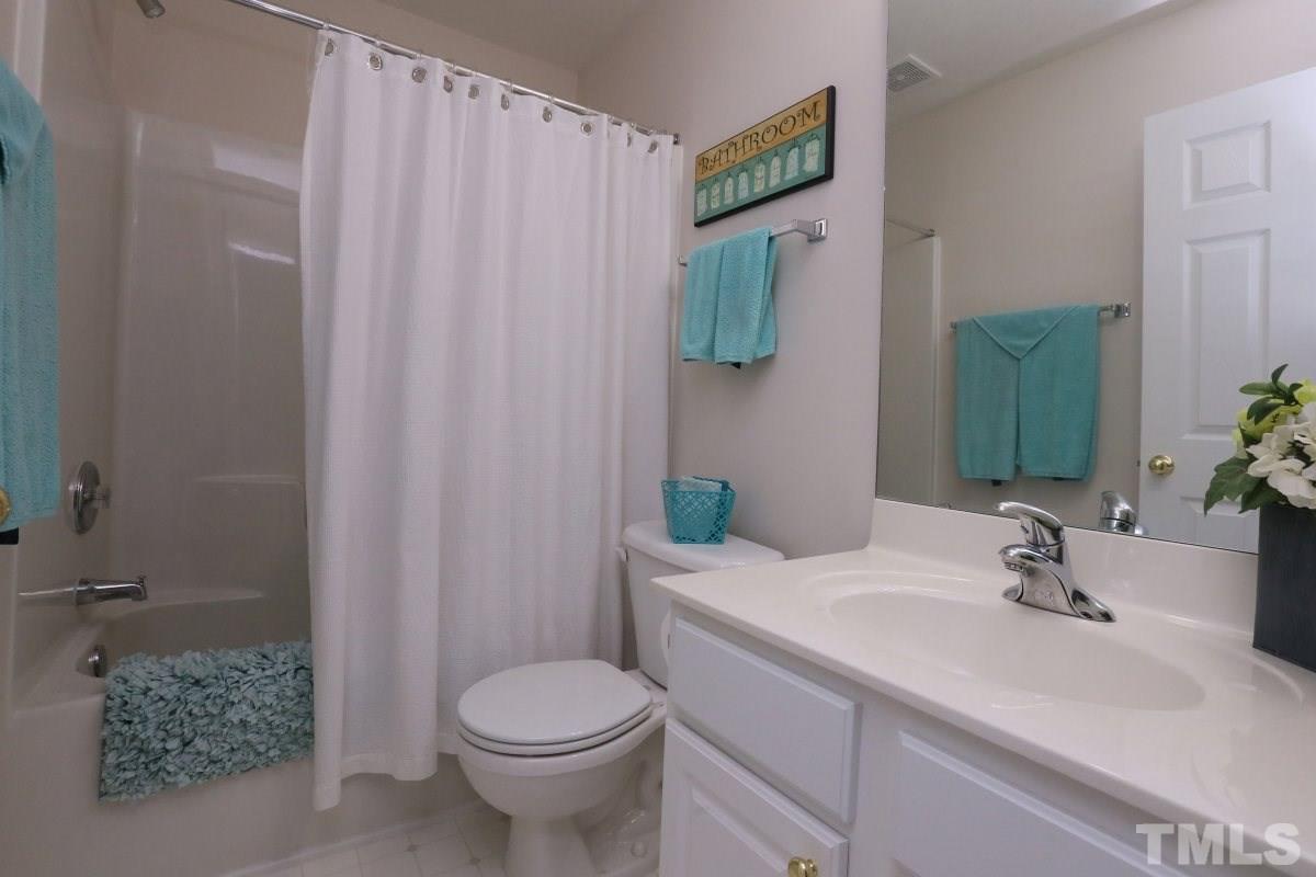 7113 Lovko Lane Raleigh, NC 27613 - Photo 18 of 25 a bathroom with a sink and toilet