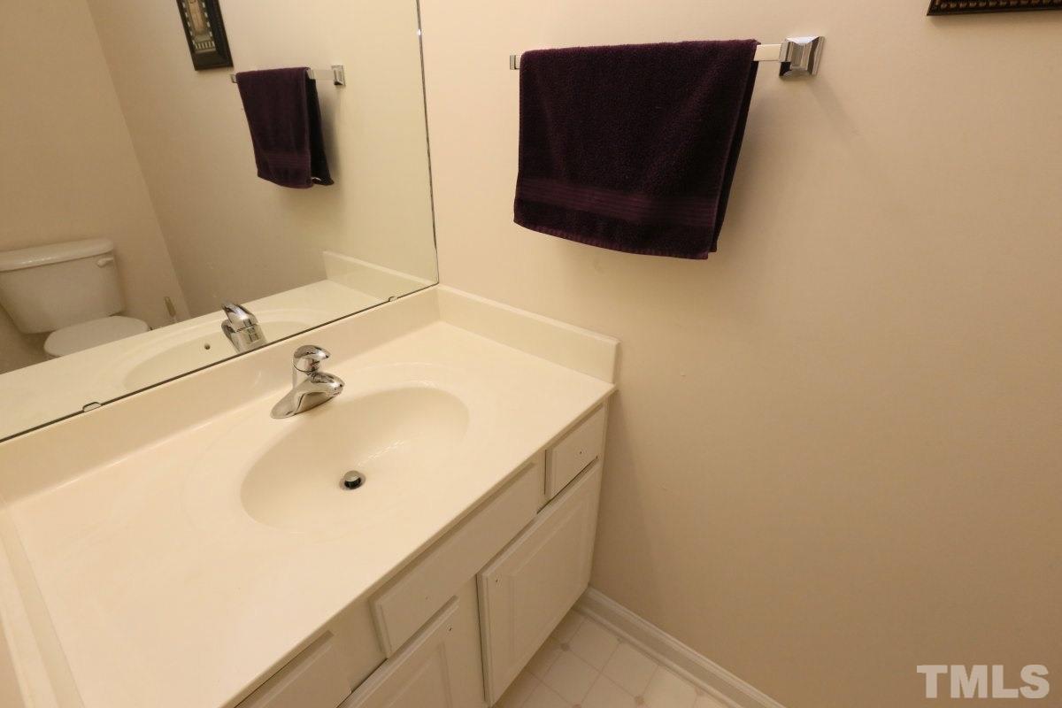 7113 Lovko Lane Raleigh, NC 27613 - Photo 20 of 25 a bathroom with a sink and a mirror