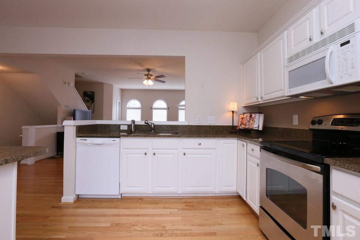 7113 Lovko Lane Raleigh, NC 27613 - Photo 3 of 25 a kitchen with stainless steel appliances granite countertop a sink and cabinets