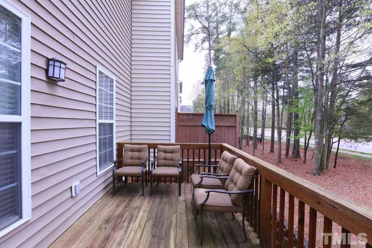 7113 Lovko Lane Raleigh, NC 27613 - Photo 23 of 25 a view of a balcony with chairs and wooden fence