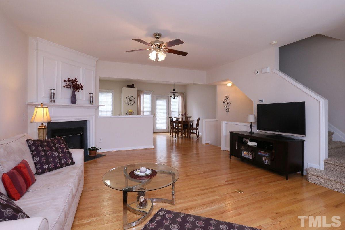 7113 Lovko Lane Raleigh, NC 27613 - Photo 4 of 25 a living room with furniture and a flat screen tv with wooden floor