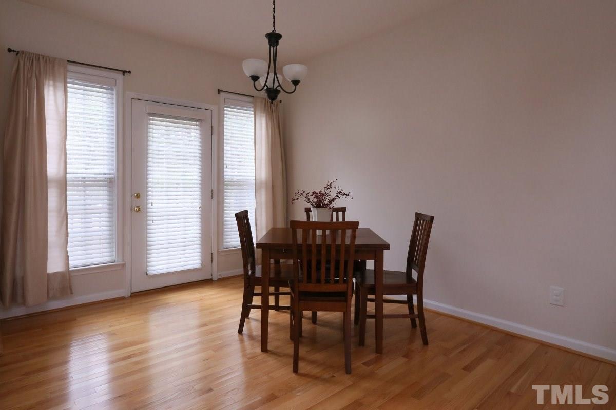 7113 Lovko Lane Raleigh, NC 27613 - Photo 9 of 25 a view of a dining room with furniture window and wooden floor