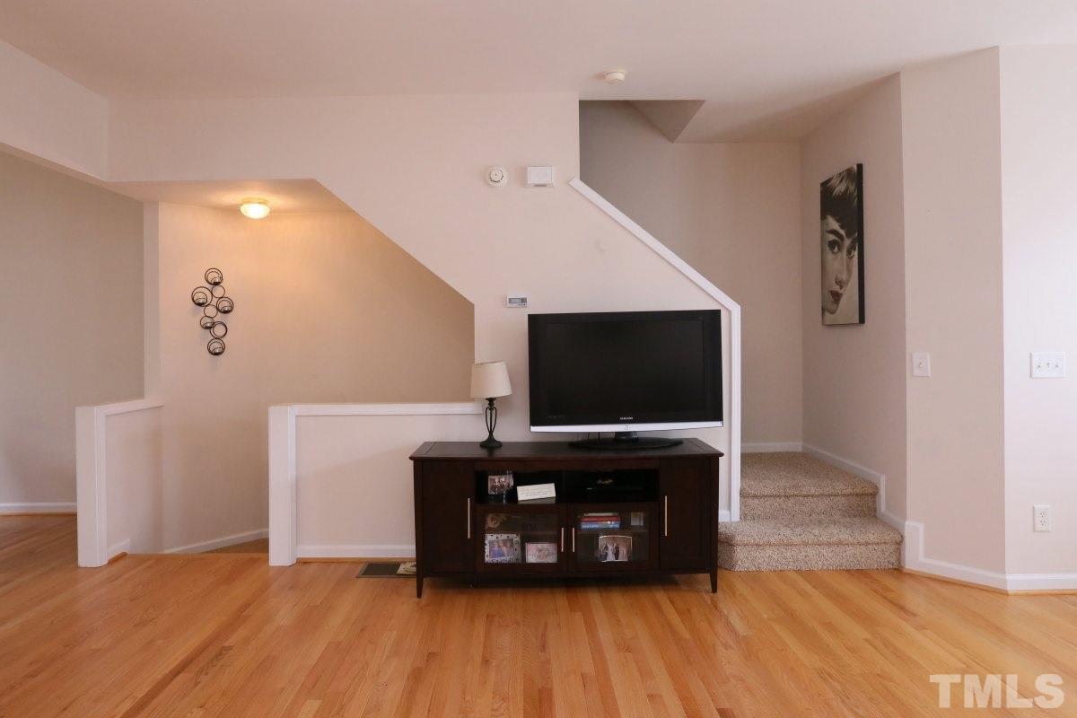 7113 Lovko Lane Raleigh, NC 27613 - Photo 10 of 25 a living room with furniture and a flat screen tv