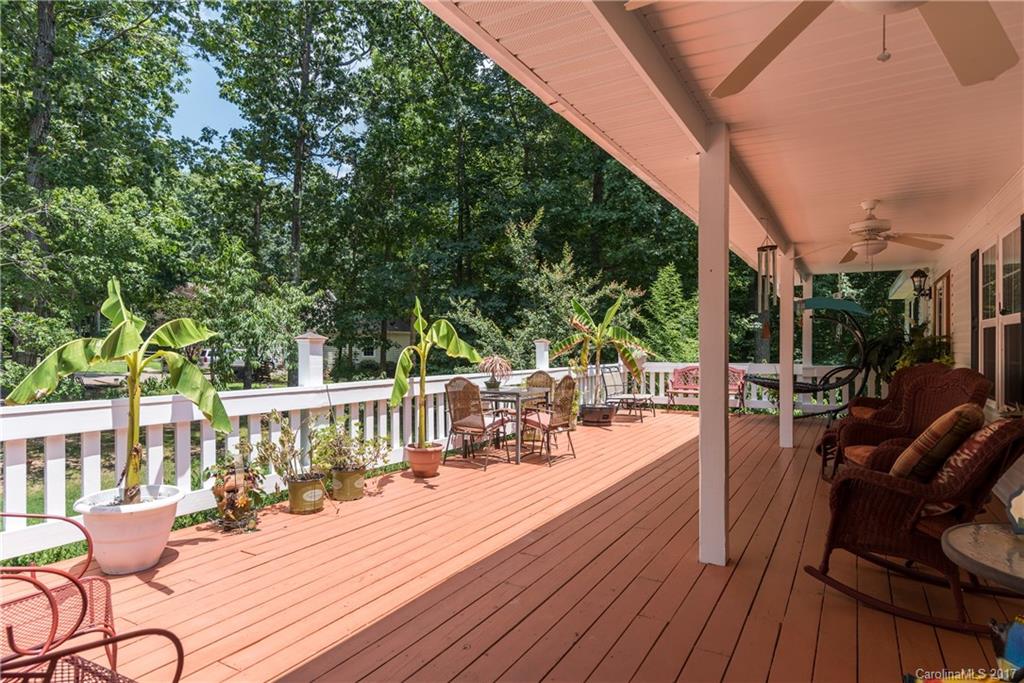 309 Edwards Road Mooresville, NC 28115 - Photo 3 of 24 a view of a patio with couches table and chairs and potted plants