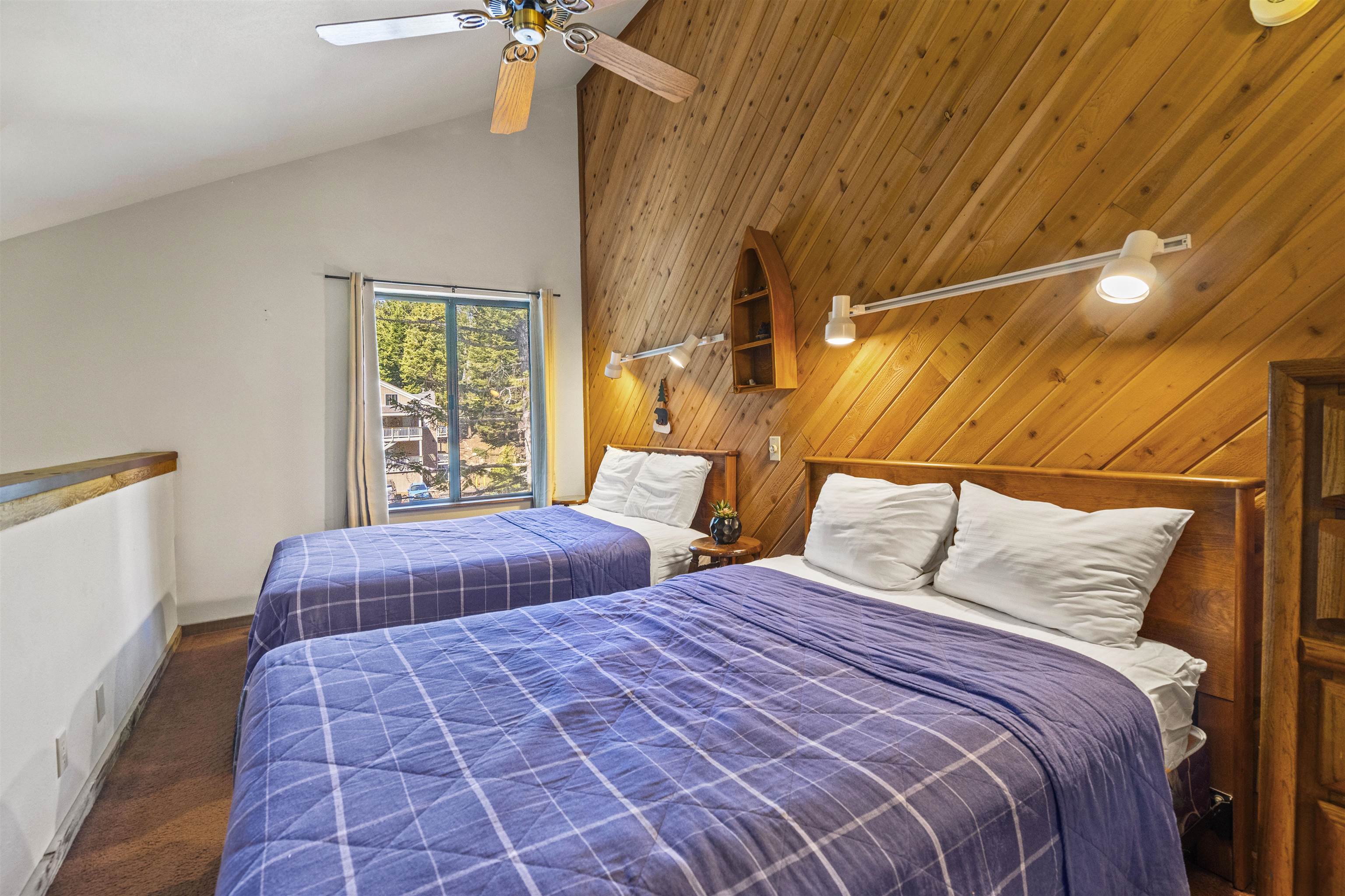 153 Lake Mary Road, Unit 114 Mammoth Lakes, CA 93546 - Photo 13 of 22 Vaulted ceiling room featuring natural wood-paneled walls and a ceiling fan