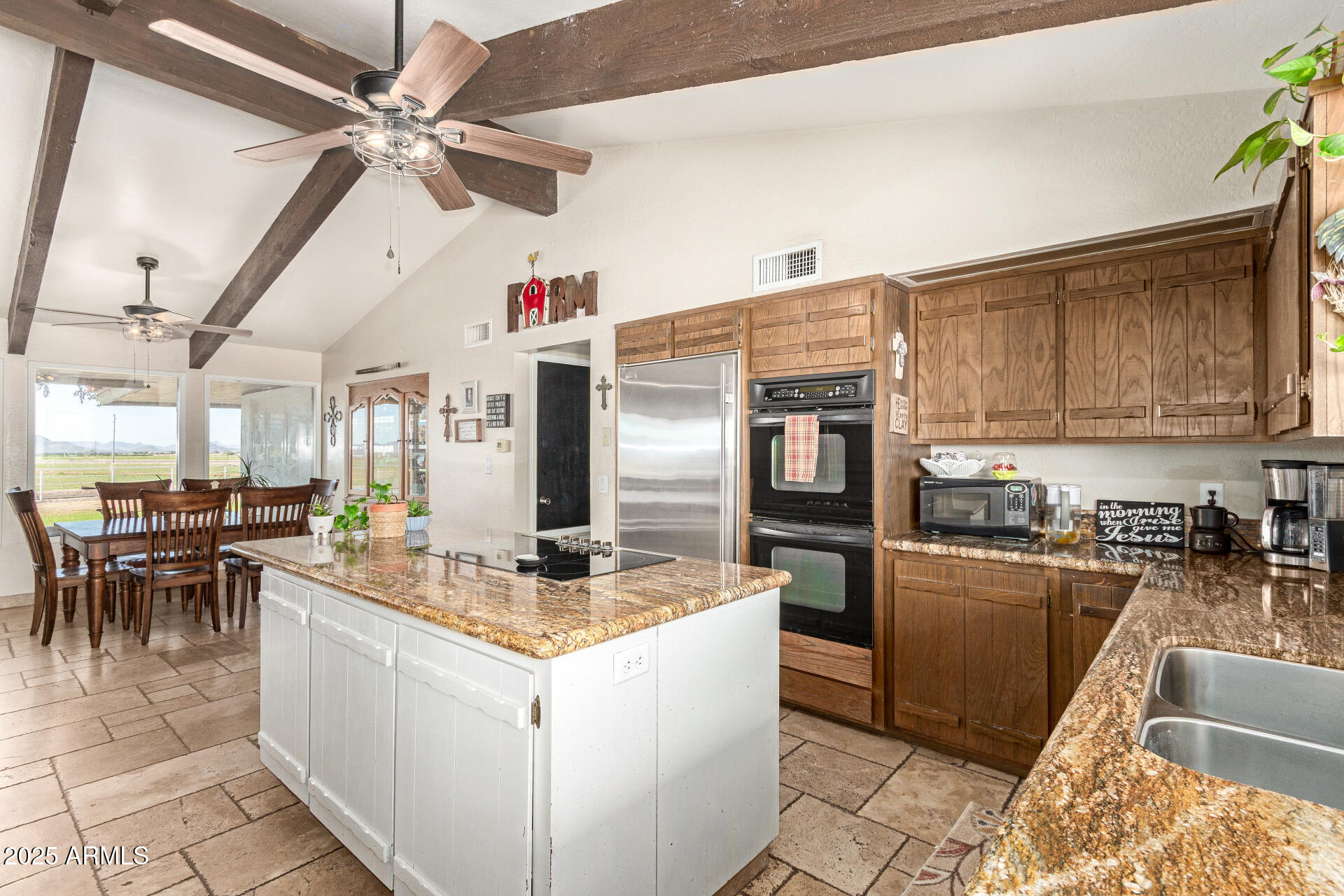 6901 South Palo Verde Road Buckeye, AZ 85326 - Photo 12 of 43 a kitchen with stainless steel appliances granite countertop a sink dishwasher stove top oven and cabinets