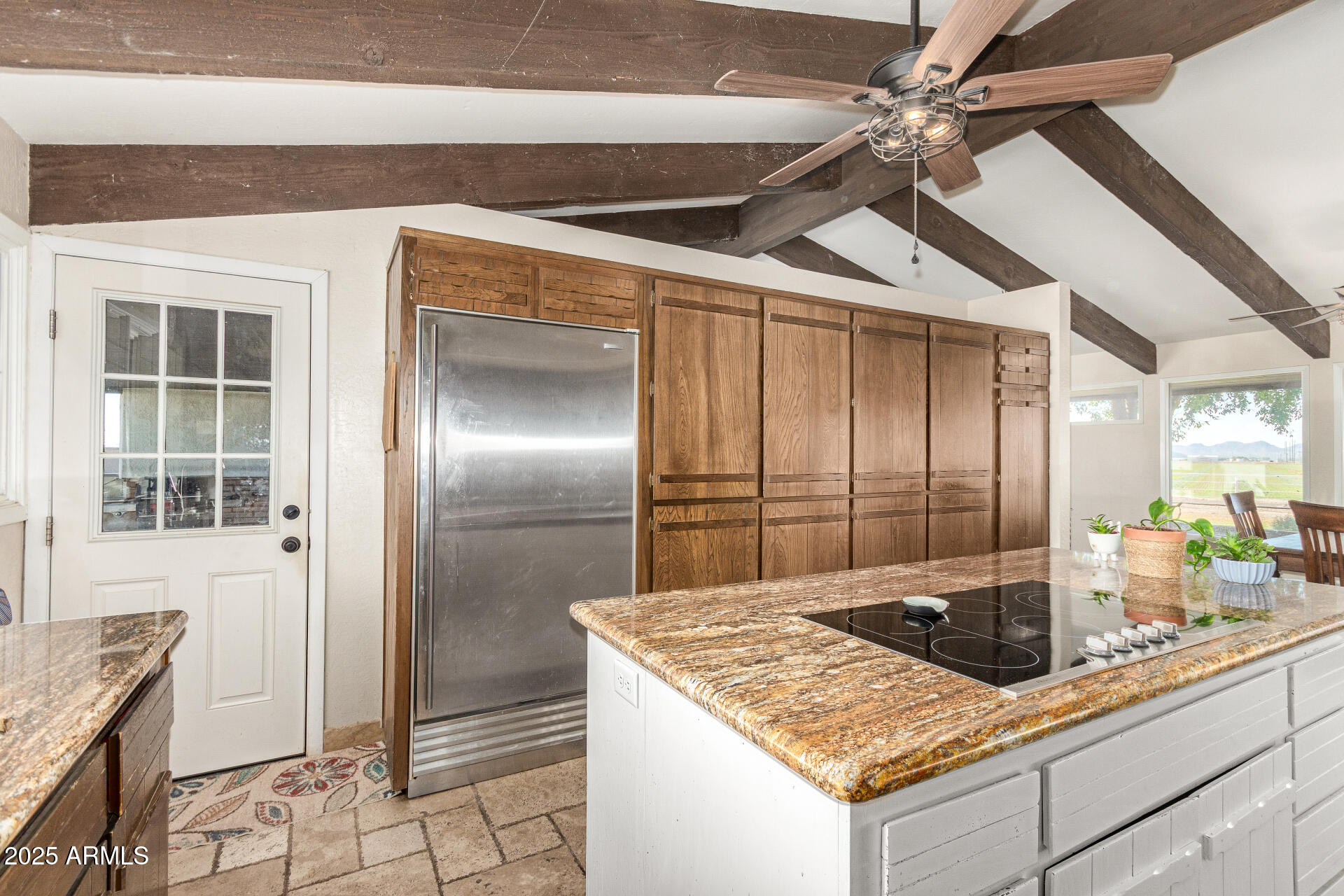 6901 South Palo Verde Road Buckeye, AZ 85326 - Photo 13 of 43 a kitchen with a stove a faucet a chandelier fan and refrigerator