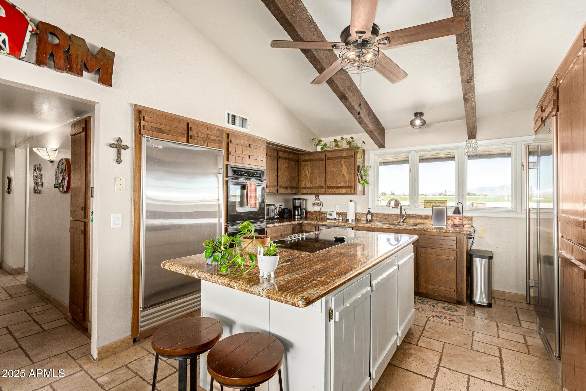 6901 South Palo Verde Road Buckeye, AZ 85326 - Photo 14 of 43 a kitchen with a refrigerator a sink a stove top oven and cabinets