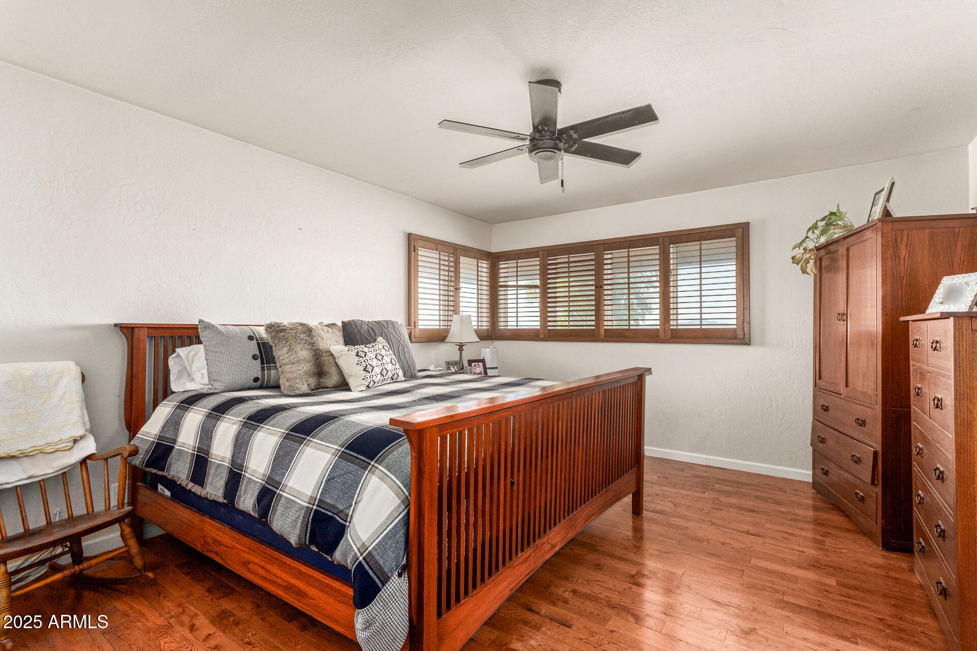 6901 South Palo Verde Road Buckeye, AZ 85326 - Photo 16 of 43 a spacious bedroom with a bed and a chandelier
