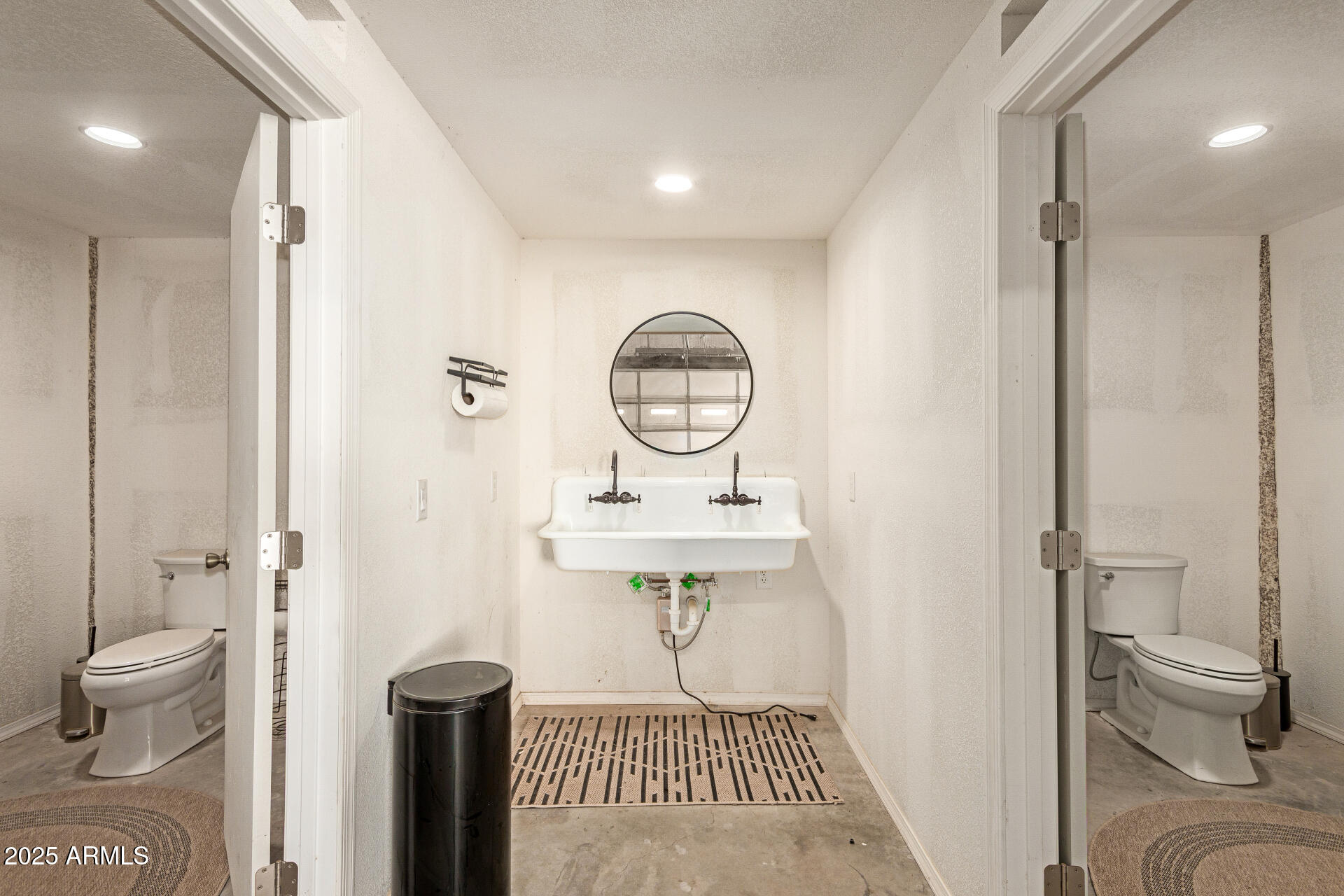 6901 South Palo Verde Road Buckeye, AZ 85326 - Photo 43 of 43 a view of a bathroom with a toilet sink and a mirror