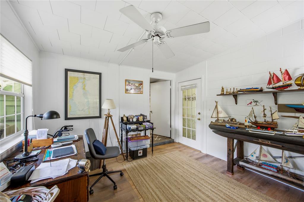 4123 Northwest 18th Place Gainesville, FL 32605 - Photo 14 of 36 a view of a workspace with furniture and a wooden floor