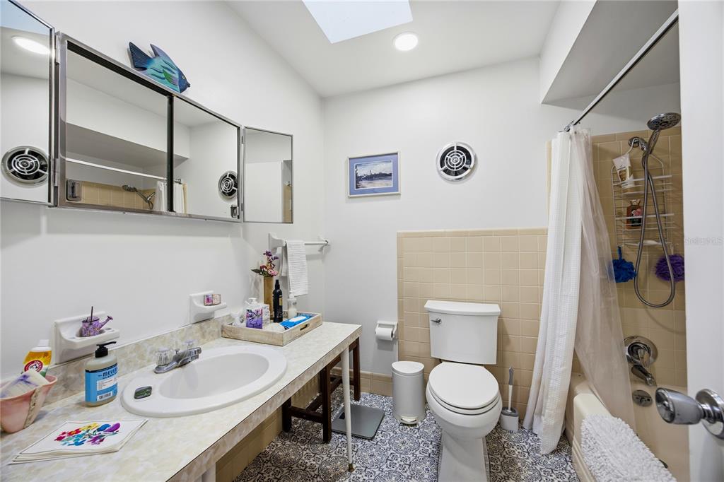 4123 Northwest 18th Place Gainesville, FL 32605 - Photo 17 of 36 a bathroom with a sink toilet and shower